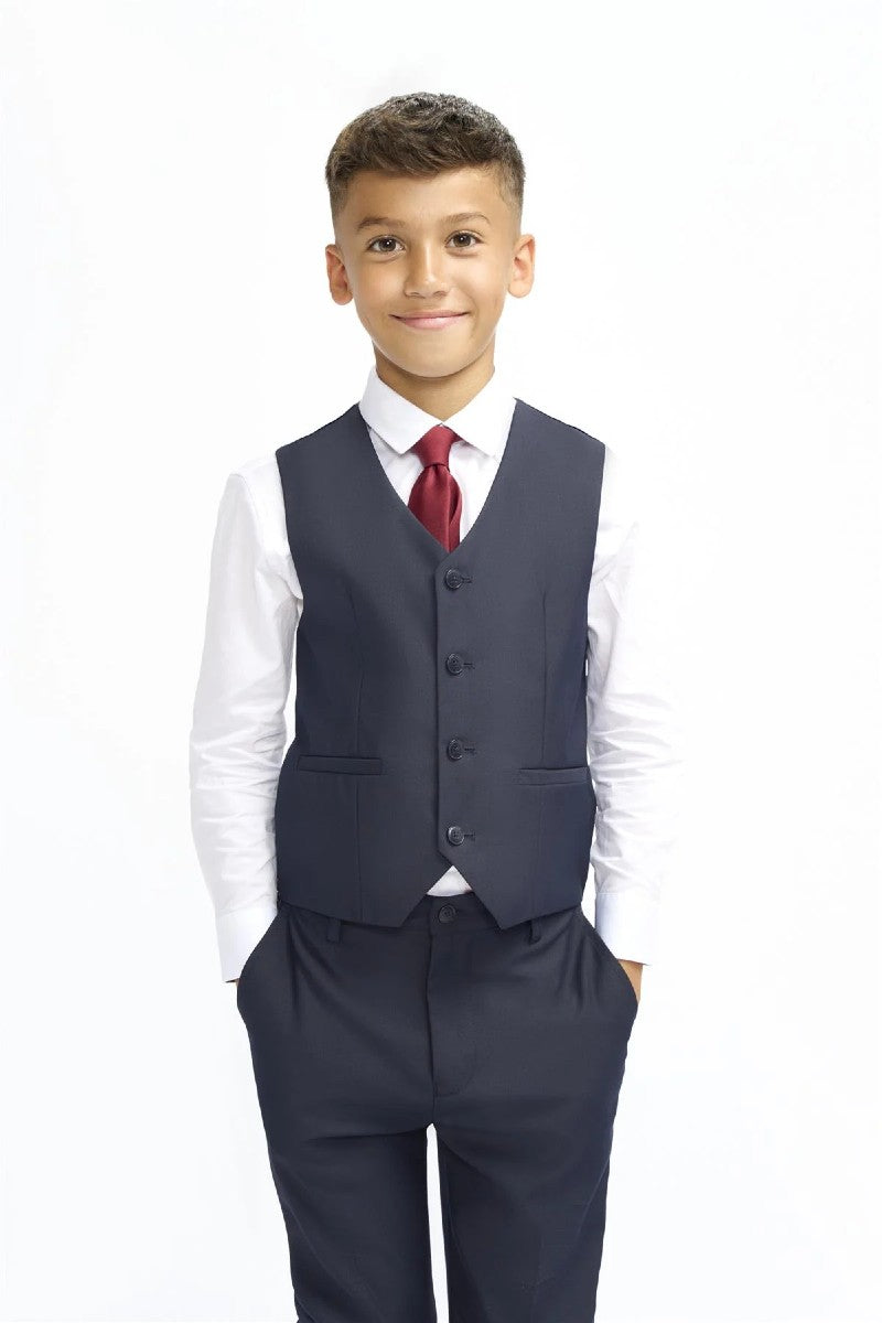 Young boy wearing a formal suit with a vest and tie on a white background