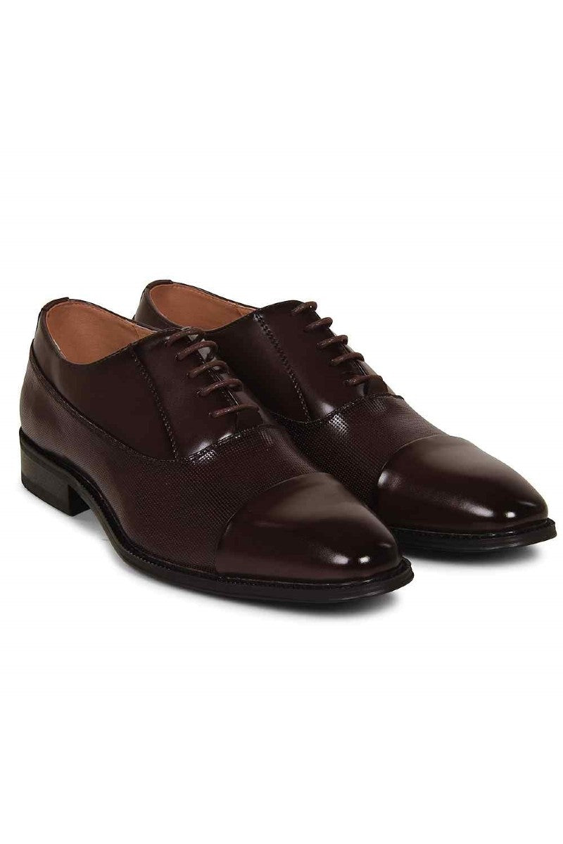 Pair of brown dress shoes on a white background